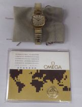 A lady's Omega gold plated and stainless steel cased wristwatch, faced by a baton dial, on an