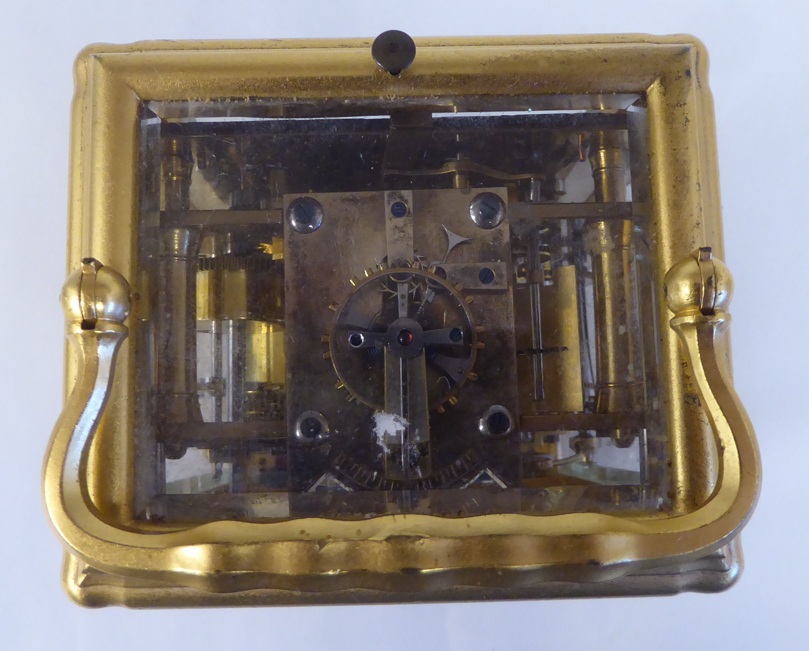 An early 20thC French lacquered brass cased carriage clock with a folding top handle and bevelled - Image 7 of 8