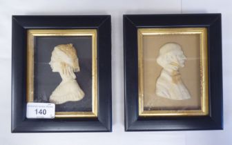 A pair of 19thC carved wax head and shoulders profile portraits, a bewhiskered man and a young