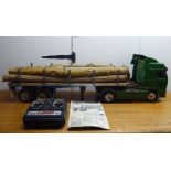 A Tamiya 1:25 scale remote controlled model tractor tuck and trailer, decorated in green livery