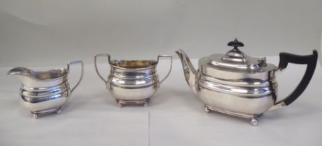 A three piece bachelor's silver tea set of oval ogee form, comprising a teapot with a swept spout,