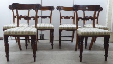 A set of six William IV rosewood framed dining chairs with rosette, scrolled and tulip carved