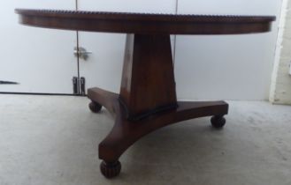 A William IV bead bordered rosewood dining table, the radiating veneered tip-top set on an incurved,
