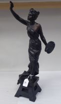 After E Villanis - a cast and patinated standing figure, a classically inspired female artist, on