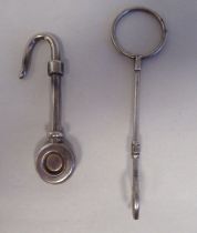 A silver napkin holder with a hooked end; and another  mixed marks