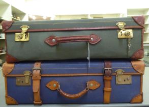 Two similar canvas bound and leather clad suitcases  9"h  28"w