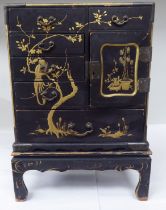 A late 19th/early 20thC Japanese black lacquered and engraved metal mounted, two-part table cabinet,