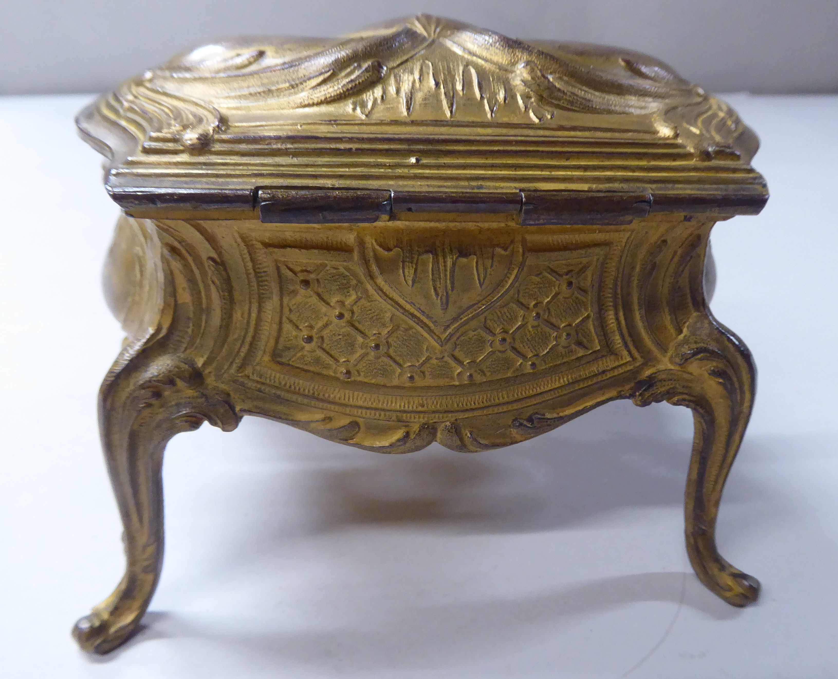 A late 19thC cast gilded metal jewellery box, fashioned as a commode, the hinged lid enclosing a - Image 5 of 10