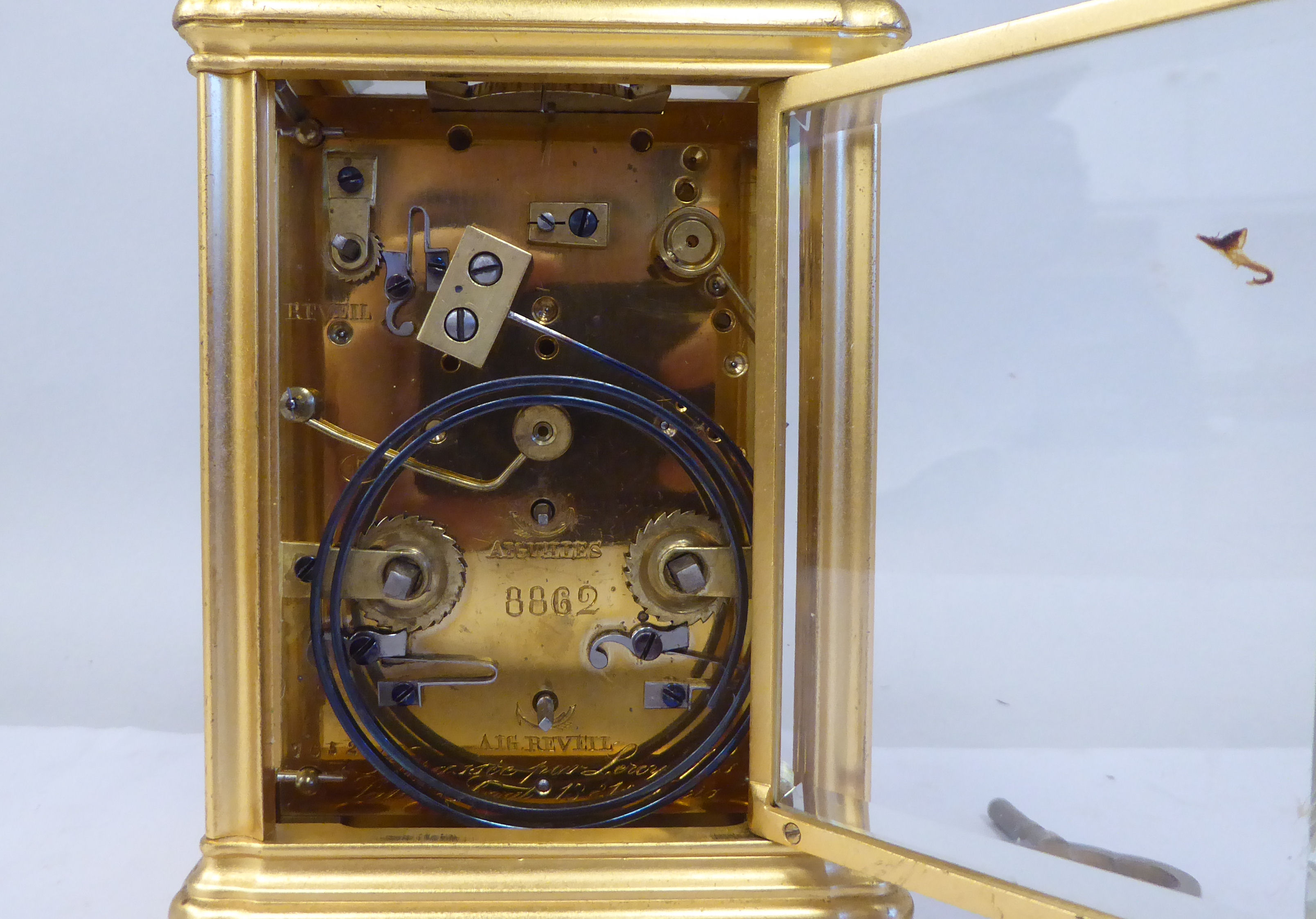 An early 20thC French lacquered brass cased carriage clock with a folding top handle and bevelled - Image 5 of 8