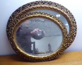 Two similar mid 20thC mirrors, each in an ornate gilded plaster frame  largest 31" x 25"