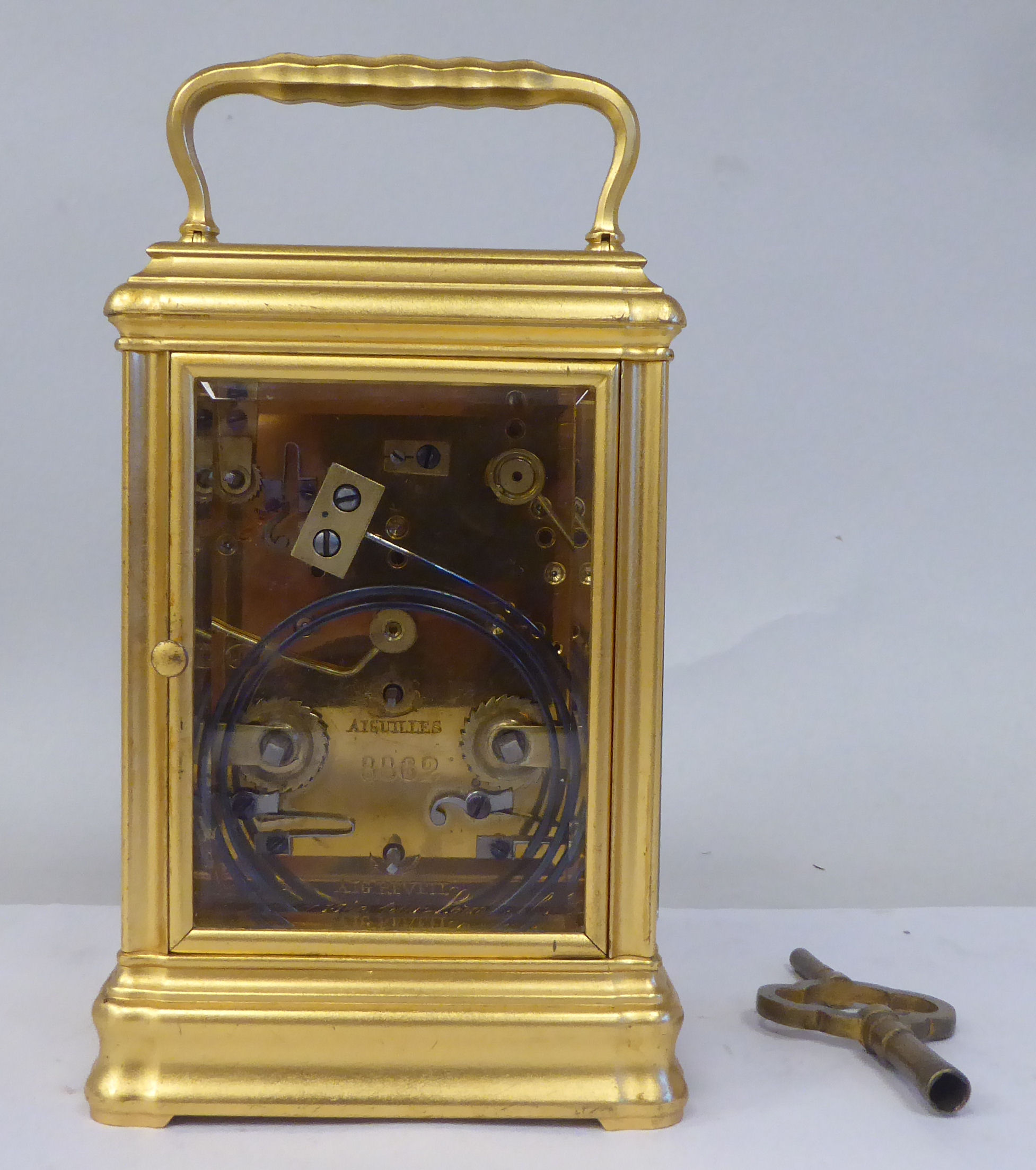 An early 20thC French lacquered brass cased carriage clock with a folding top handle and bevelled - Image 4 of 8