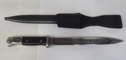 A German World War II military bayonet with a two-part handgrip, the engraved blade 9.5"L in a steel
