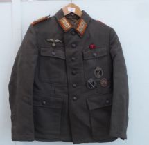 A German army tunic with three awards (Please Note: this lot is subject to the statement made in the