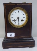 A late 19thC French part ebonised and string inlaid mantel clock of box design; the bell strike