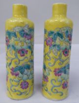 A pair of late 19th/early 20thC Chinese porcelain bottle vases, decorated in coloured famille