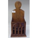 A stained pine hanging candle box, the front panel carved in Gothic inspired tracery  15"h  6"w