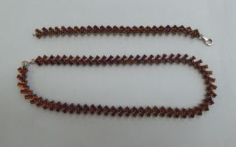 A silver bracelet, set with amber coloured beads; and a matching necklace