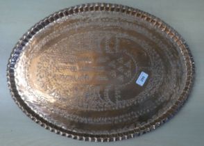 An oval copper tray, impressed with repeating designs  stamped CPC  1970  22"dia