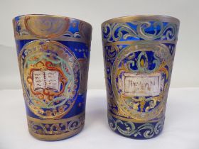 A pair of 19thC Continental blue glass beakers of tapered form, similarly overpainted and gilded