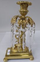 A 19thC gilt metal candlestick with a detachable sconce, in a vase shape socket, over a series of