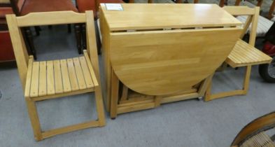 A modern beech drop-leaf dining table, raised on block feet  30"h  52"L; and a matching set of six