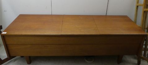 A 1960/70s Leak teak cased low cabinet with three hinged flaps, contains a stereo 30 and a Garrard