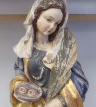 A 19thC carved and painted wooden figure 'St Lucy, Patron Saint of Sight and Sufferers of Eye