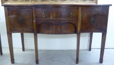 An early 20thC Georgian design mahogany serpentine front serving sideboard with two central drawers,