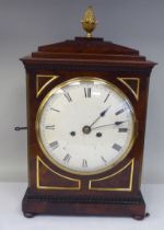 A George III mahogany cased bracket clock with a stepped top, gilt metal pineapple finial and