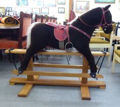 A Pegasus fur fabric rocking horse, on a stained beech stand  39"h