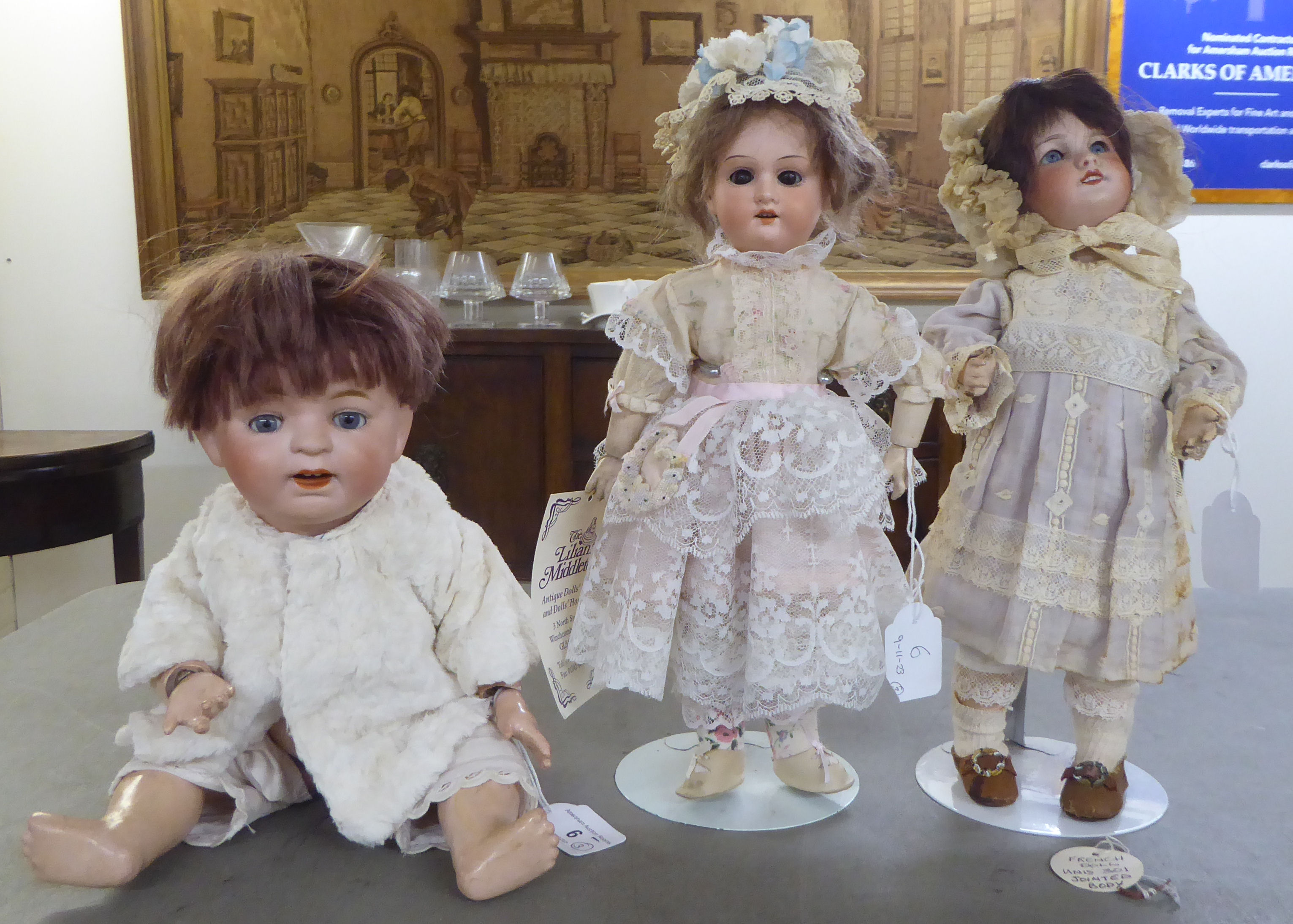 Three bisque head dolls: to include an early 20thC example with painted features, on a jointed