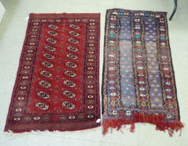 Rugs: to include a Bokhara with elephant foot motifs, on a red ground  50" x 31"