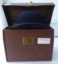 A Colletts of London black silk top hat  8" front to back; and a Lock & Co black bowler  8.25" front