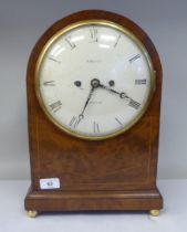 A George III round arch cased and string inlaid bracket clock with gilt metal flank lion mask and