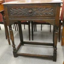 An early 20thC Jacobean style, oak single drawer side table, raised on turned and block legs  30"