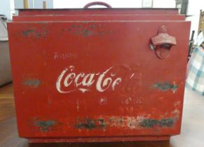 A modern cast and red painted metal bound cool box, branded for 'Coca-Cola'  15"h  18"w