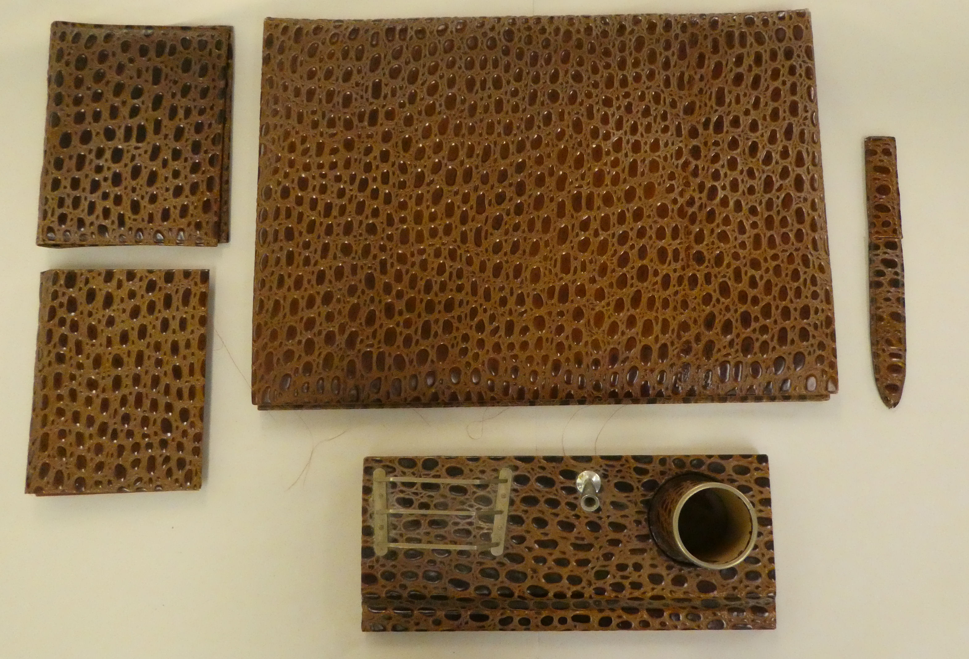 A modern crocodile skin effect desk set, comprising a desk tidy, blotter, letter knife and folders