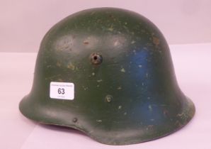 A military design, painted steel helmet with a hide liner and buckled chinstrap (Please Note: this