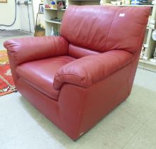 A modern red faux hide upholstered armchair