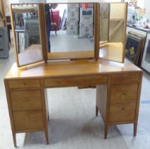 A 1960s/1970s bleached mahogany seven drawer dressing table, surmounted by a triptych mirror  51"