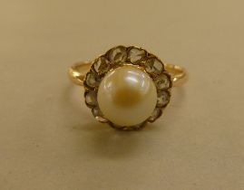 A yellow metal pearl and diamond set cluster ring