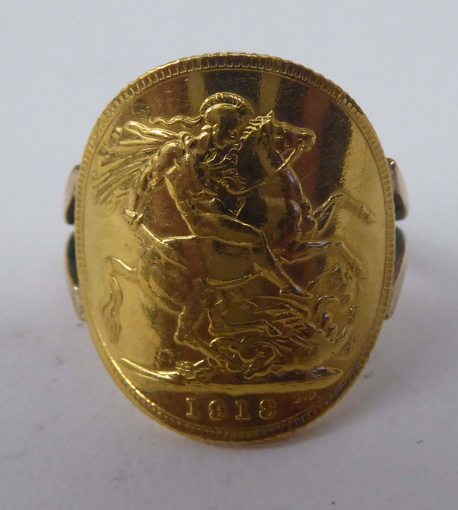 A gold coloured metal signet ring, incorporating a George V sovereign, St George on the obverse