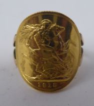A gold coloured metal signet ring, incorporating a George V sovereign, St George on the obverse