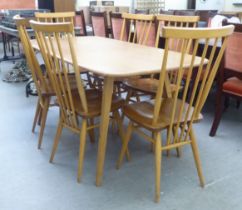 An Ercol blonde elm dining table, raised on square, tapered legs  30"h  60"L; and a set of six model