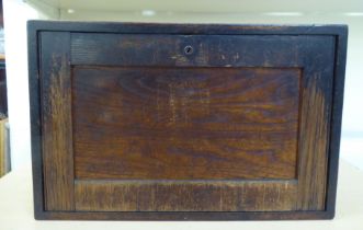 A late Victorian oak craftsman's chest with a lockable panel front, enclosing five graduated