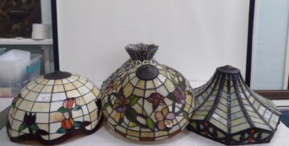 Four dissimilar Tiffany inspired, coloured panel, lead glazed centre light shades  largest 18"dia