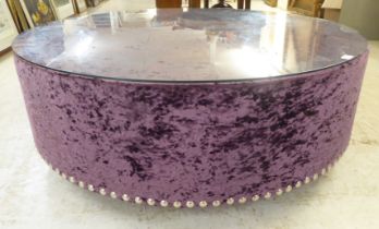 A modern stud upholstered crushed purple velvet coffee table, on a plinth  17"h  47"dia