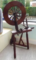A 20thC stained pine spinning wheel  46"h