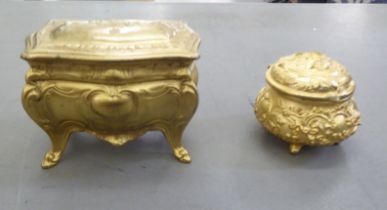 Two dissimilar French gilded cast metal, fabric lined jewellery boxes, one fashioned as a chest  5"