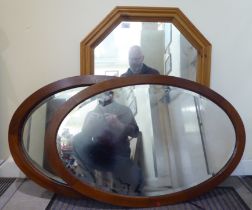 Modern mirrors, viz. two ovoid examples  both 36" x 23"; and another with canted corners  36" x 25"